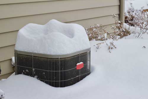 Frozen AC Unit in snow, fixed by Vanport Mechanical in Vancouver WA