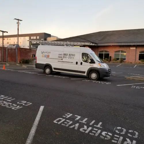 A Vanport Mehanical & Fire Sprinkler parked in front of commercial building