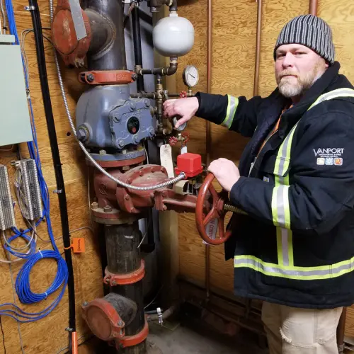 A Vanport Mechanical & Fire Sprinkler technician working on a sprinkler system