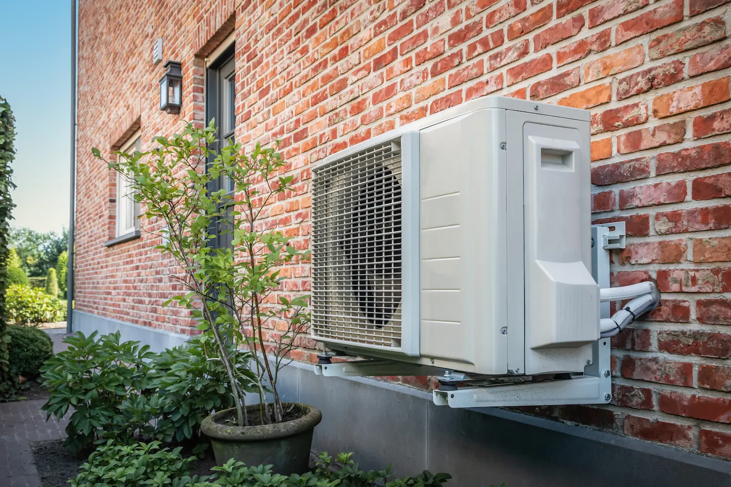 exterior of a brick home with a heat pump system
