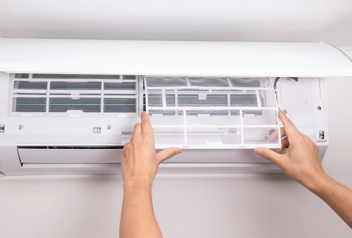 A homeowner installation an air filter to an HVAC system to improve indoor air quality (IAQ)