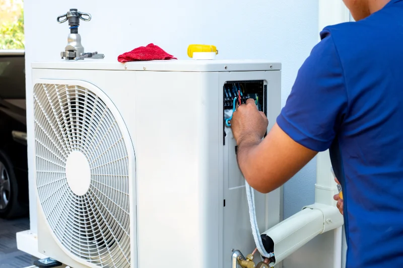A Vanport technician repairing a heat pump in Vancouver WA.