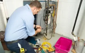 furnace technician inspects a gas furnace in a vancouver wa home